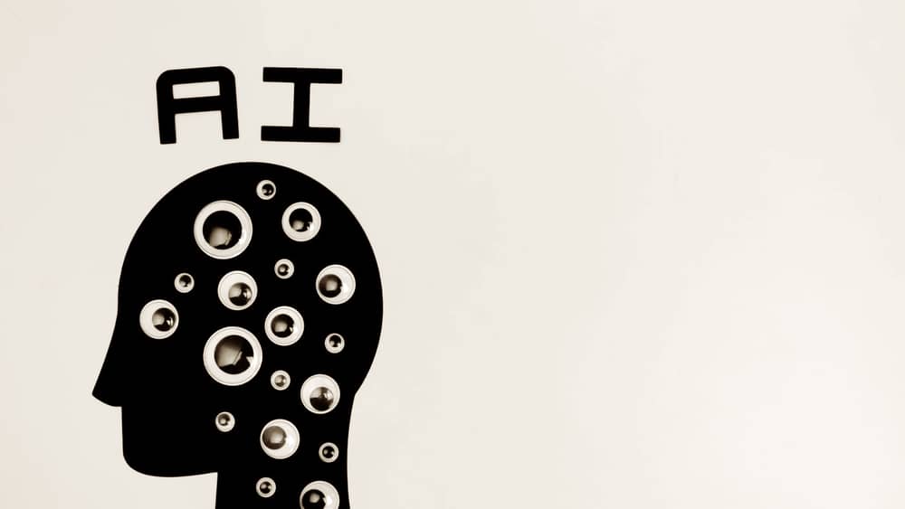 Abstract graphic of a head labelled AI filled with watching eyes