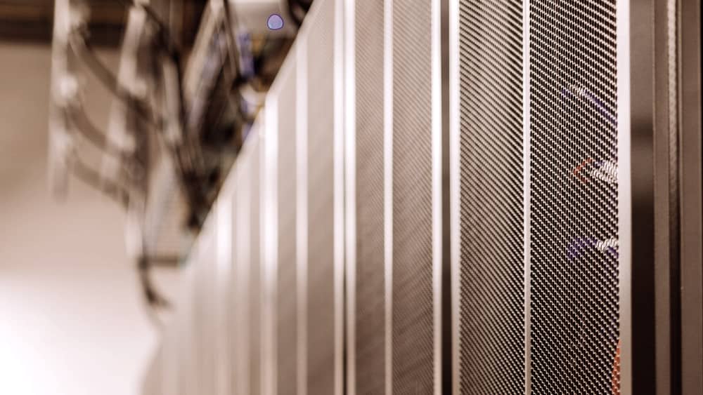 Black server racks with optical fibre cabling