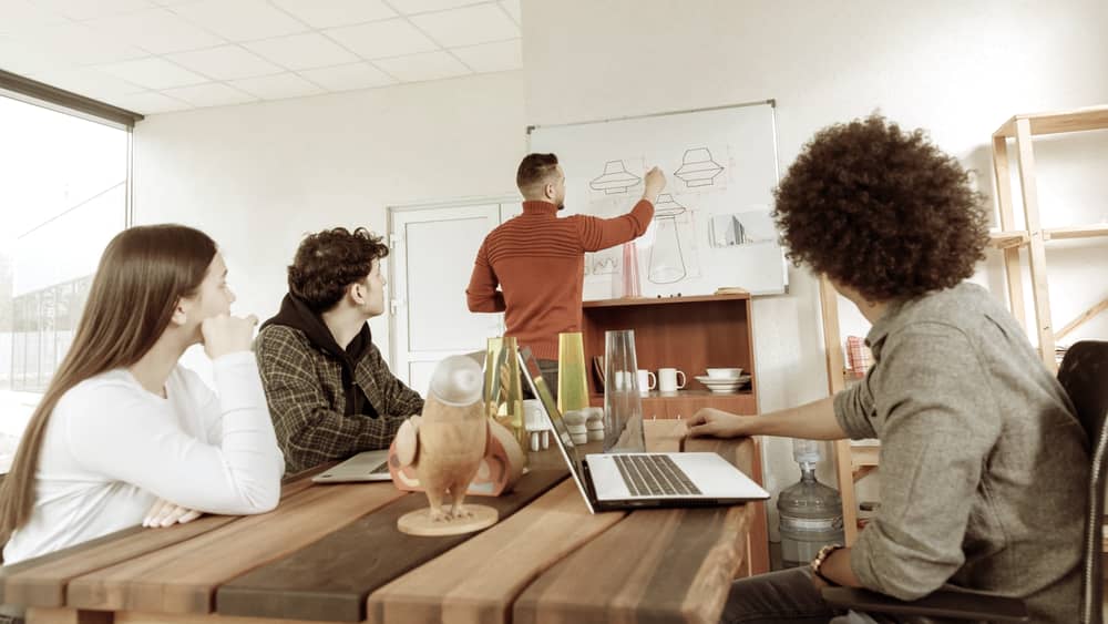 Young adults collaborating on design ideas in a modern office