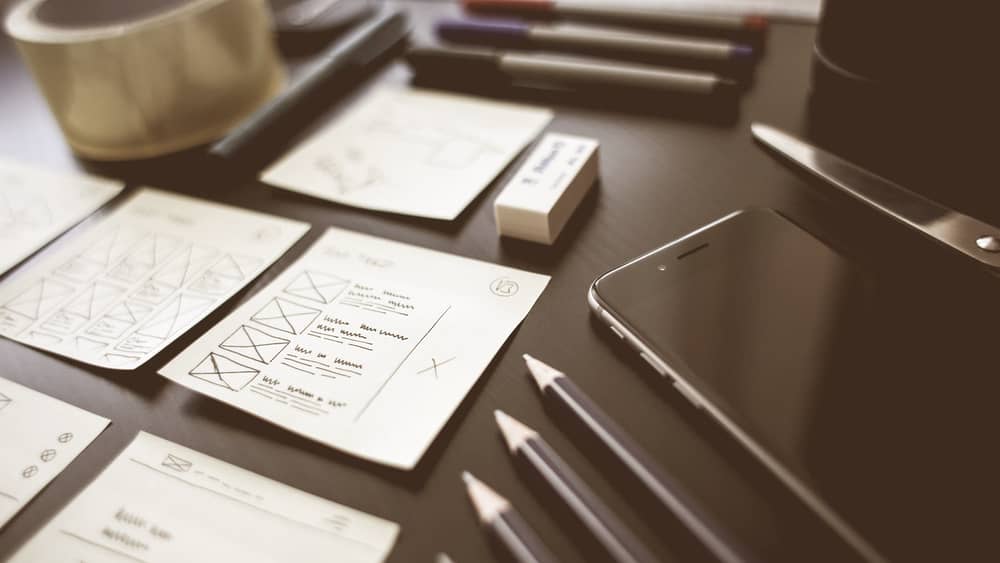 Creative workspace with design plans, pencils and office tools