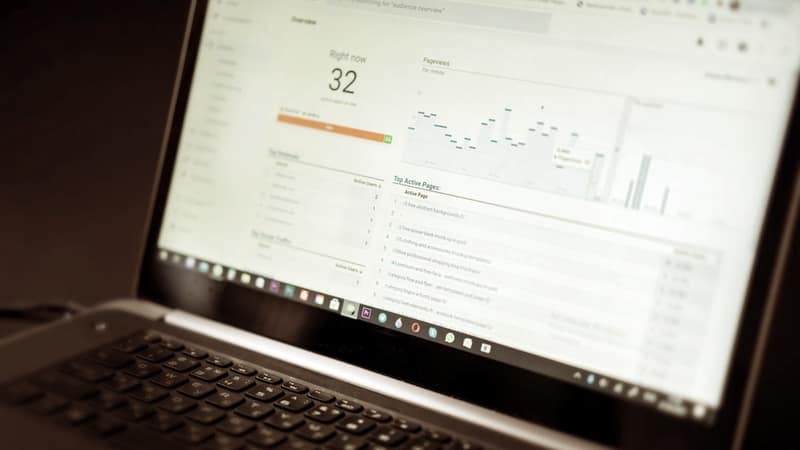 Laptop screen showing an analytics dashboard of charts